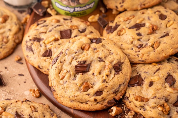 Chunky Monkey Pudding Cookies on a wooden board.