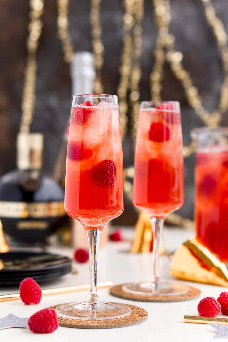 New Year's Eve Champagne Punch is loaded with Triple Sec, blackberry brandy, Chambord, pineapple juice, ginger ale, and champagne for a drink that's sure to impress all your NYE party guests!
