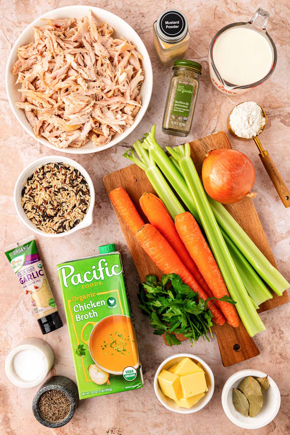 Ingredients to make chicken and wild rice soup on a table.