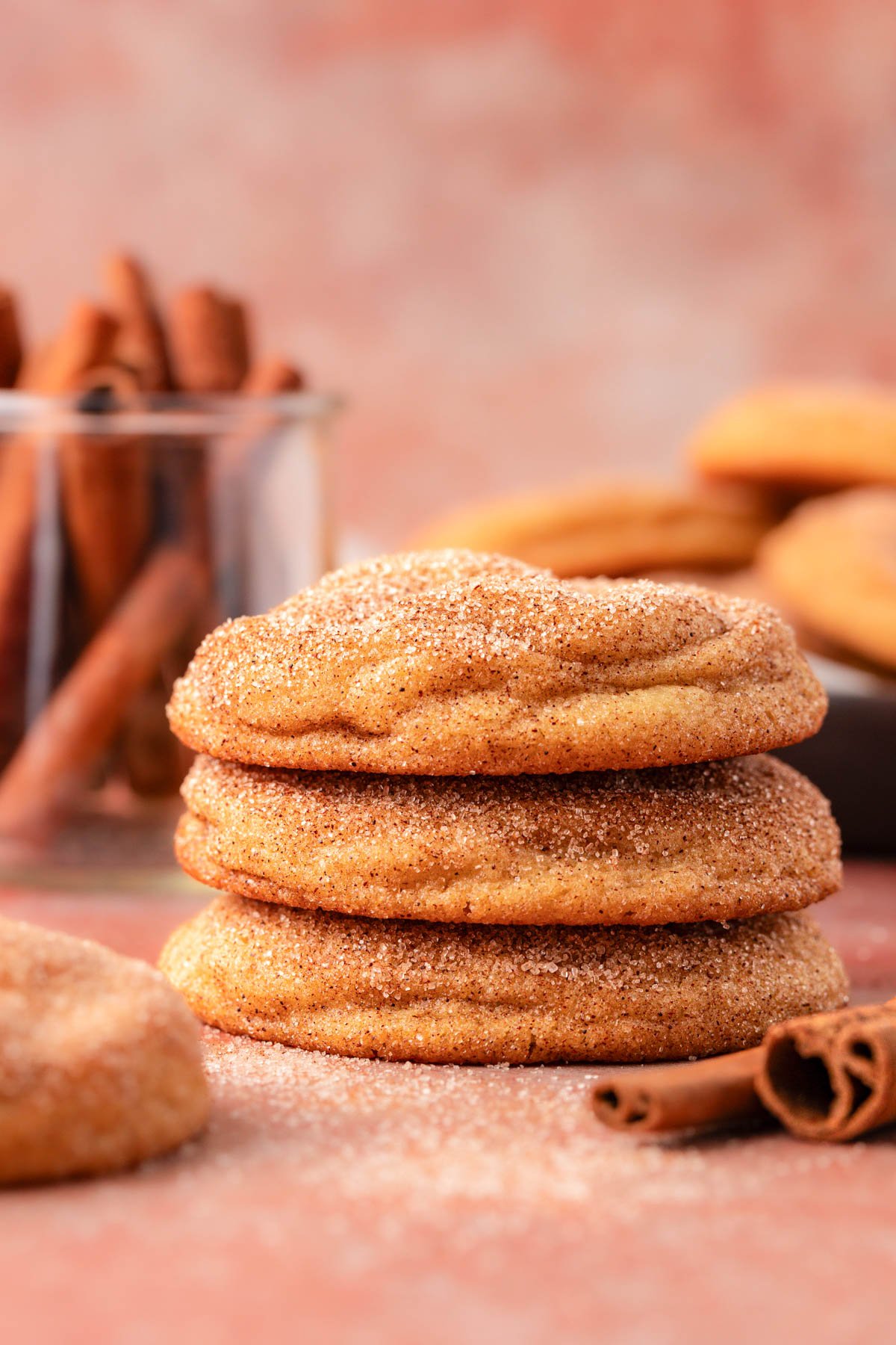 A stack of three snickerdoodle cookies on a table.