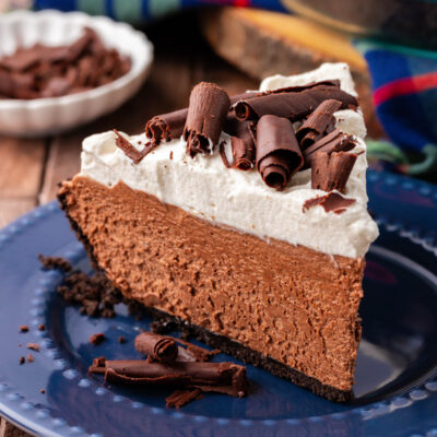 A slice of chocolate french silk pie on a blue plate.