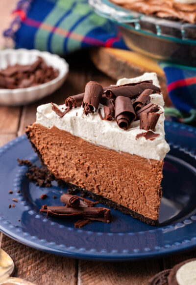 A slice of chocolate french silk pie on a blue plate.