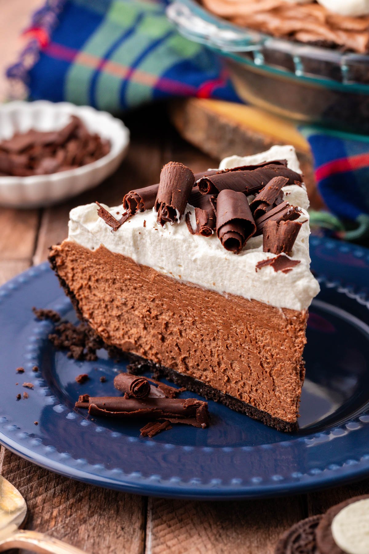 A slice of chocolate french silk pie on a blue plate.