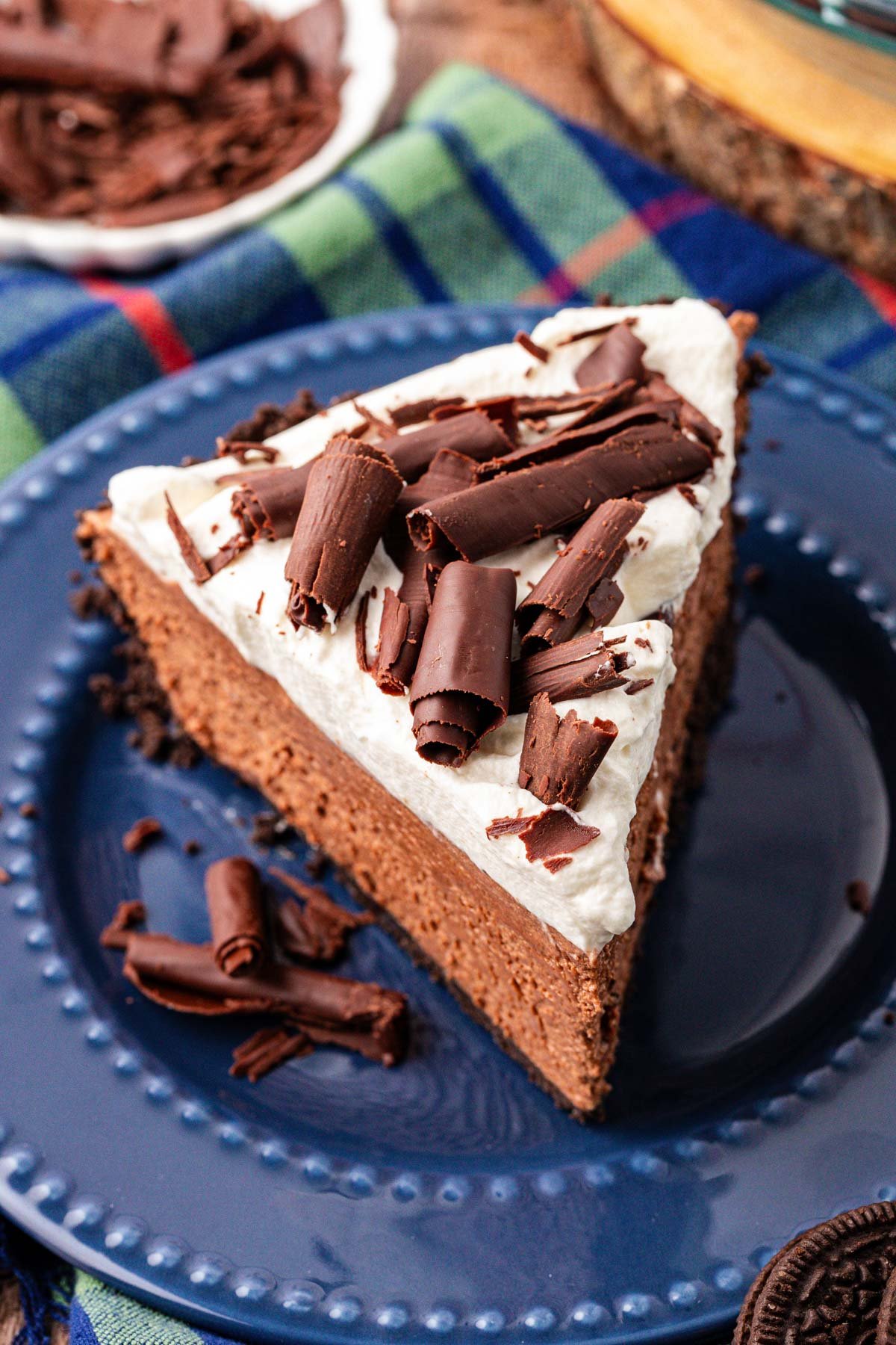 A slice of chocolate french silk pie on a blue plate.