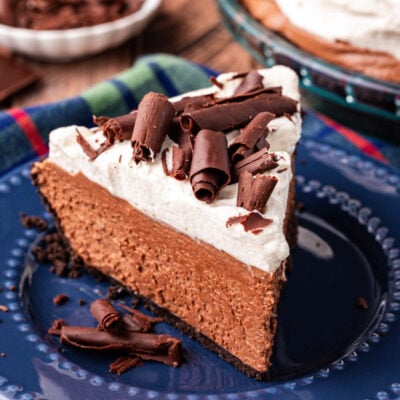 A slice of chocolate french silk pie on a blue plate.