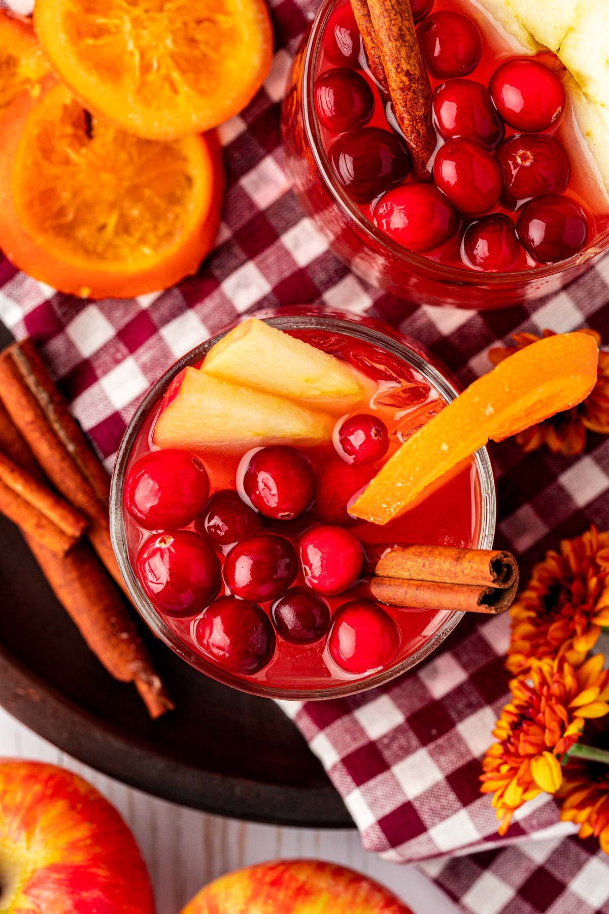 Overhead photo of two glasses of red punch for Thanksgiving.