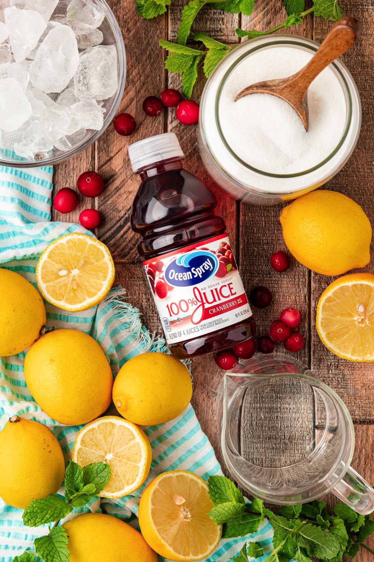 Overhead photo of ingredients to make pink lemonade on a table.