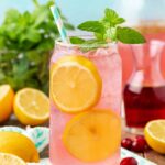 Close up of a glass filled with homemade pink lemonade.