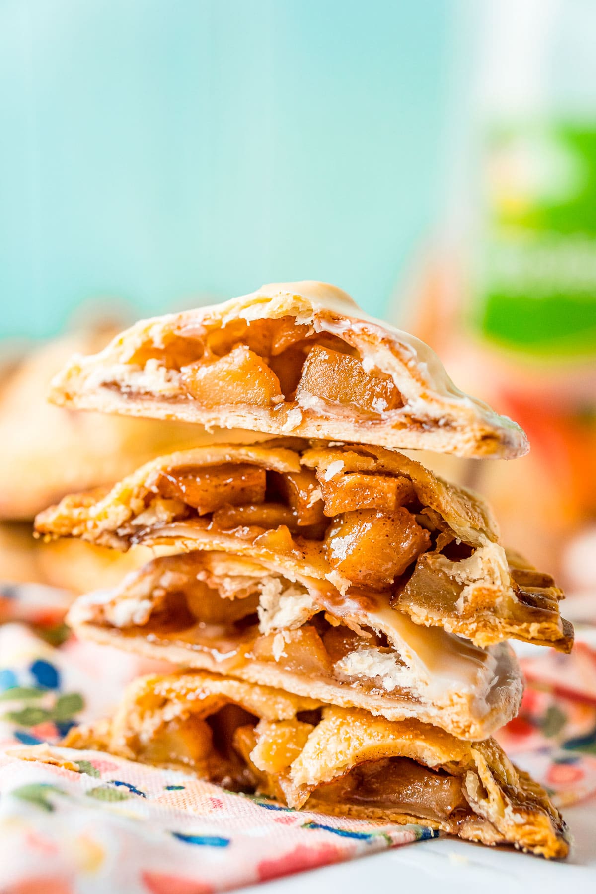 A stack of apple hand pies that have been cut in half.