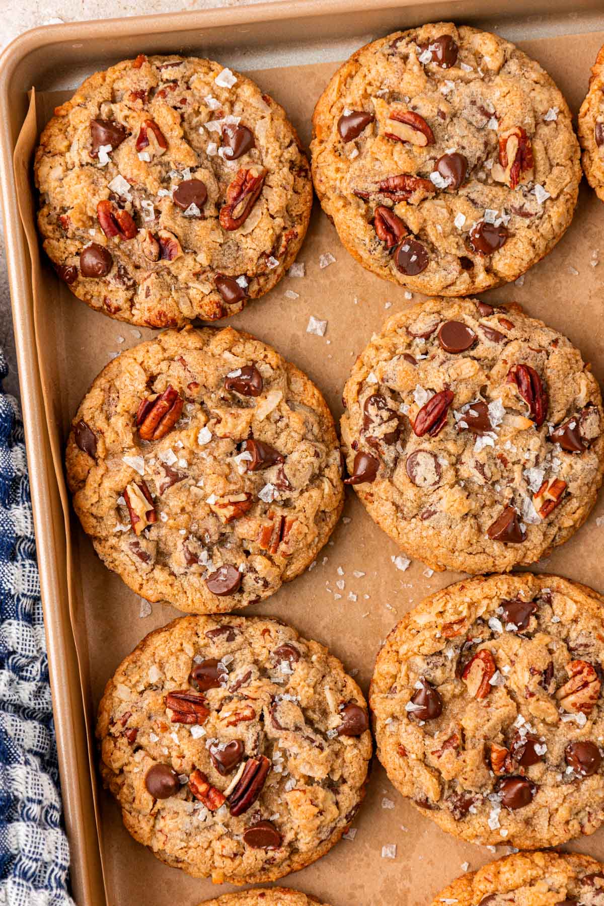 Baked cowboy cookies on a sheet pan.