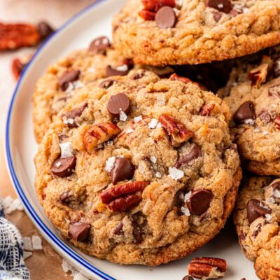 Close up of cowboy cookies on a white plate with a blue rim.