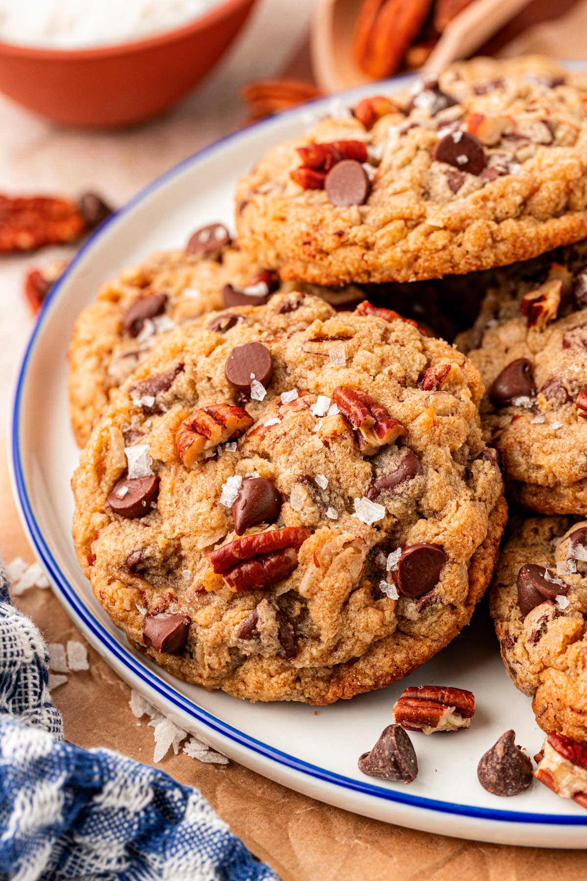 Close up of cowboy cookies on a white plate with a blue rim.