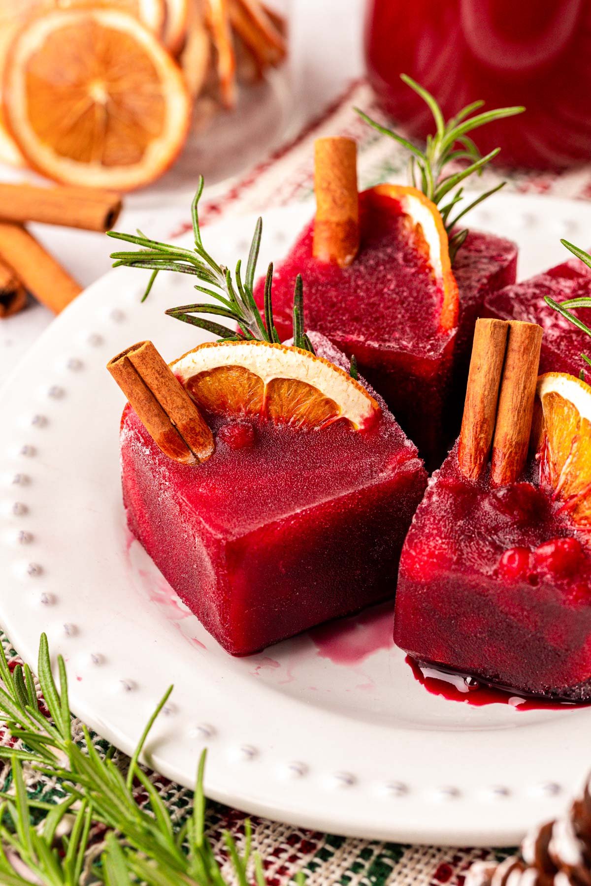 Christmas Ice Cubes made with pomegranate juice on a plate.