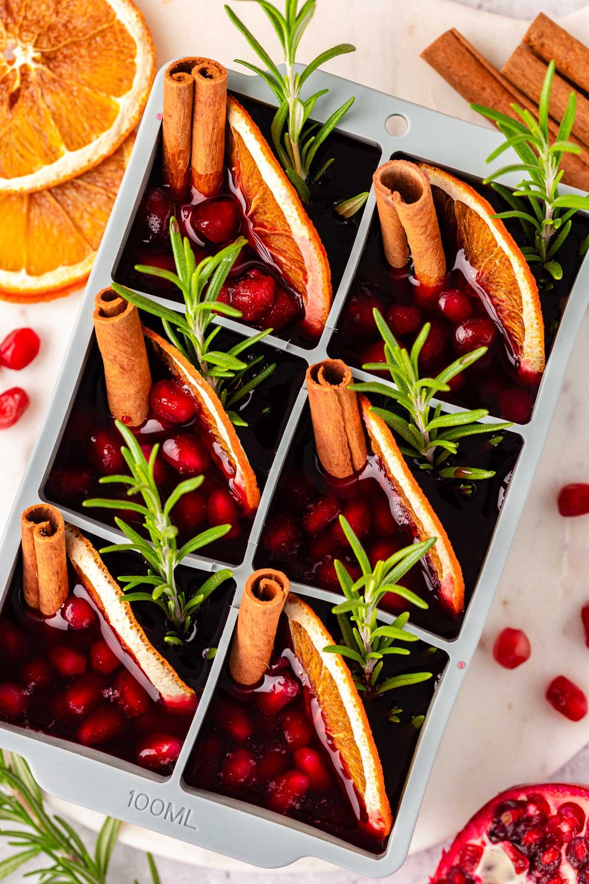 Close up of juice and drink garnishes in an ice cube tray ready to freeze.