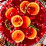 Overhead photo of a bowl of Christmas Punch on a table ready for a party.