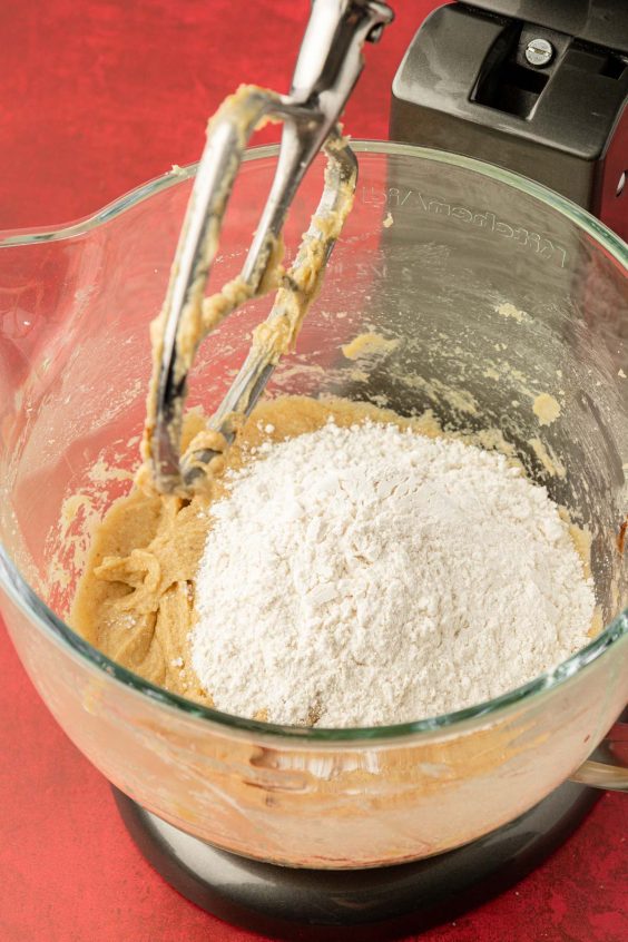 Dry ingredients being added to wet ingredients to make cookie dough.