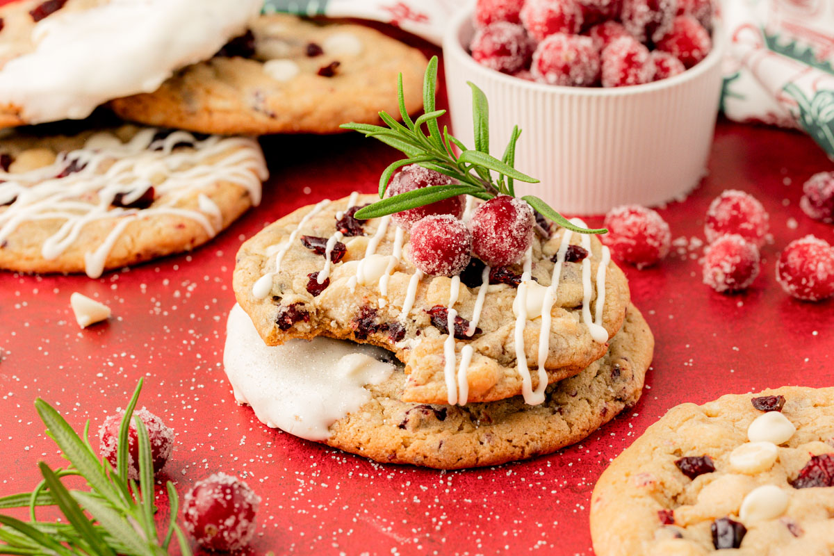 Close up of cranberry white chocolate cookies on a red table.