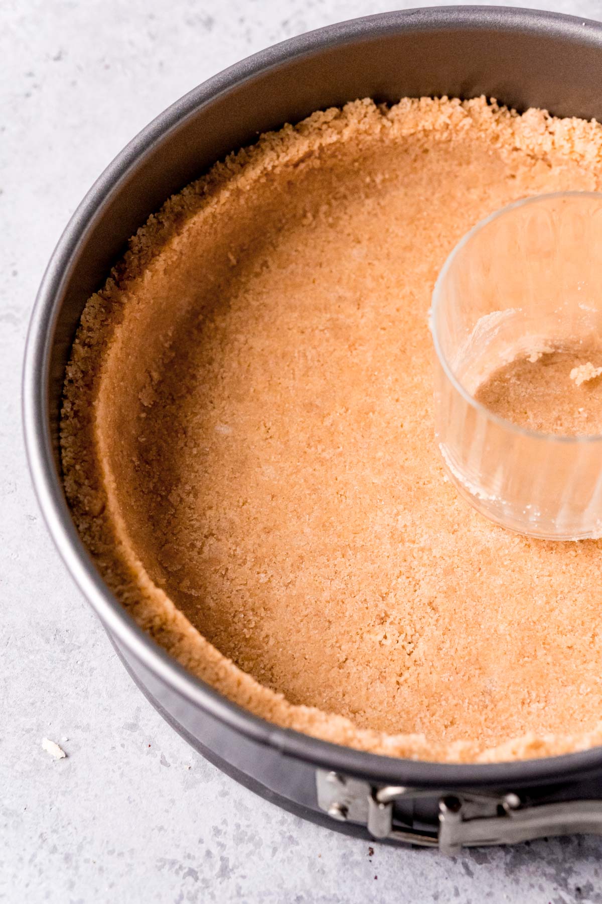 Shortbread cookie crust in a springform pan.