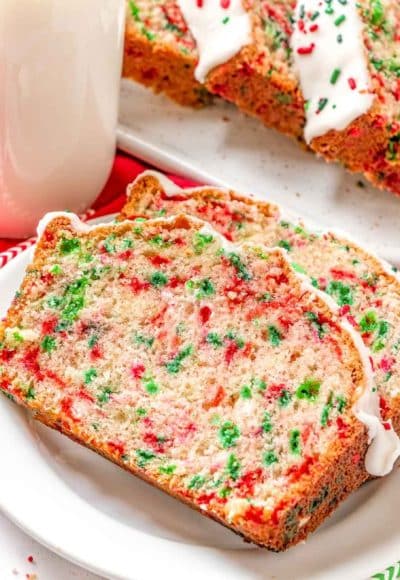 Close up photo of two slices of christmas bread on a white plate.