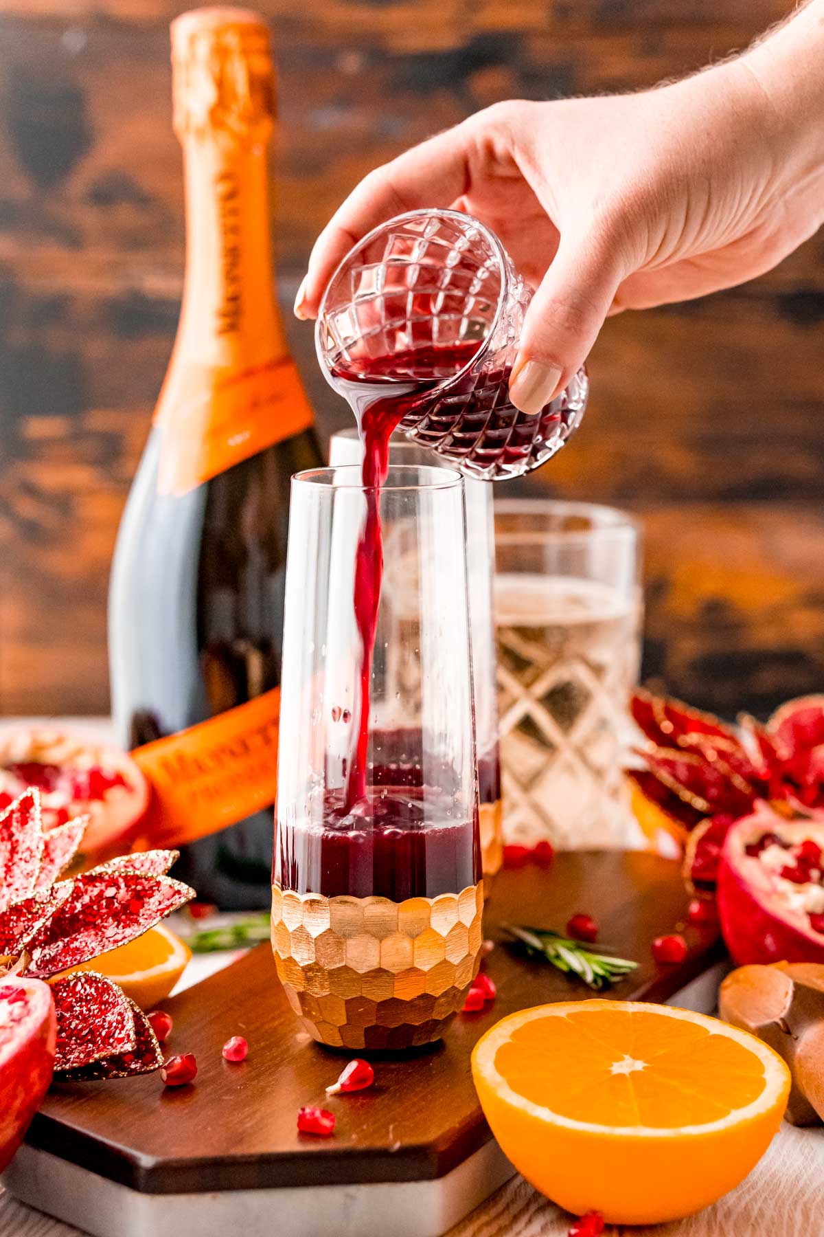 Pomegranate juice being poured into a fluted glass.