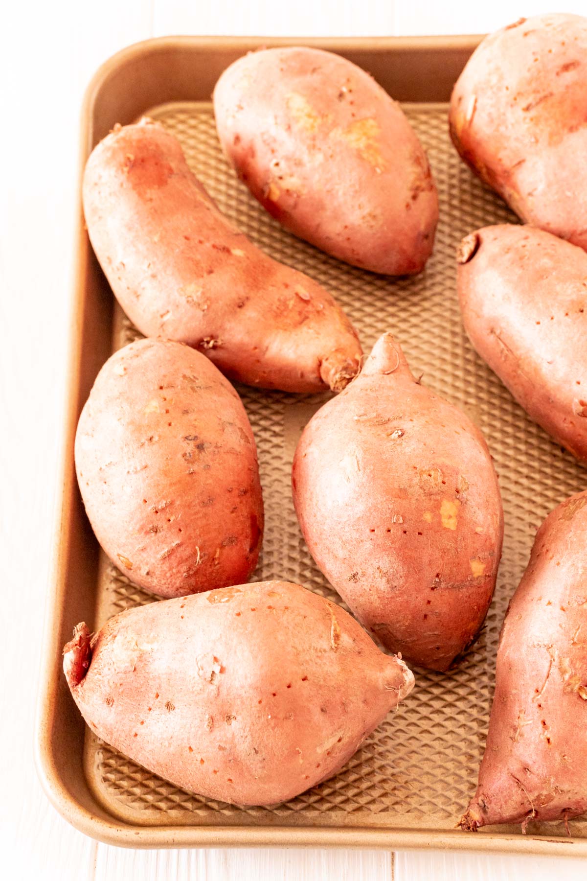 Sweet potatoes on a baking sheet.