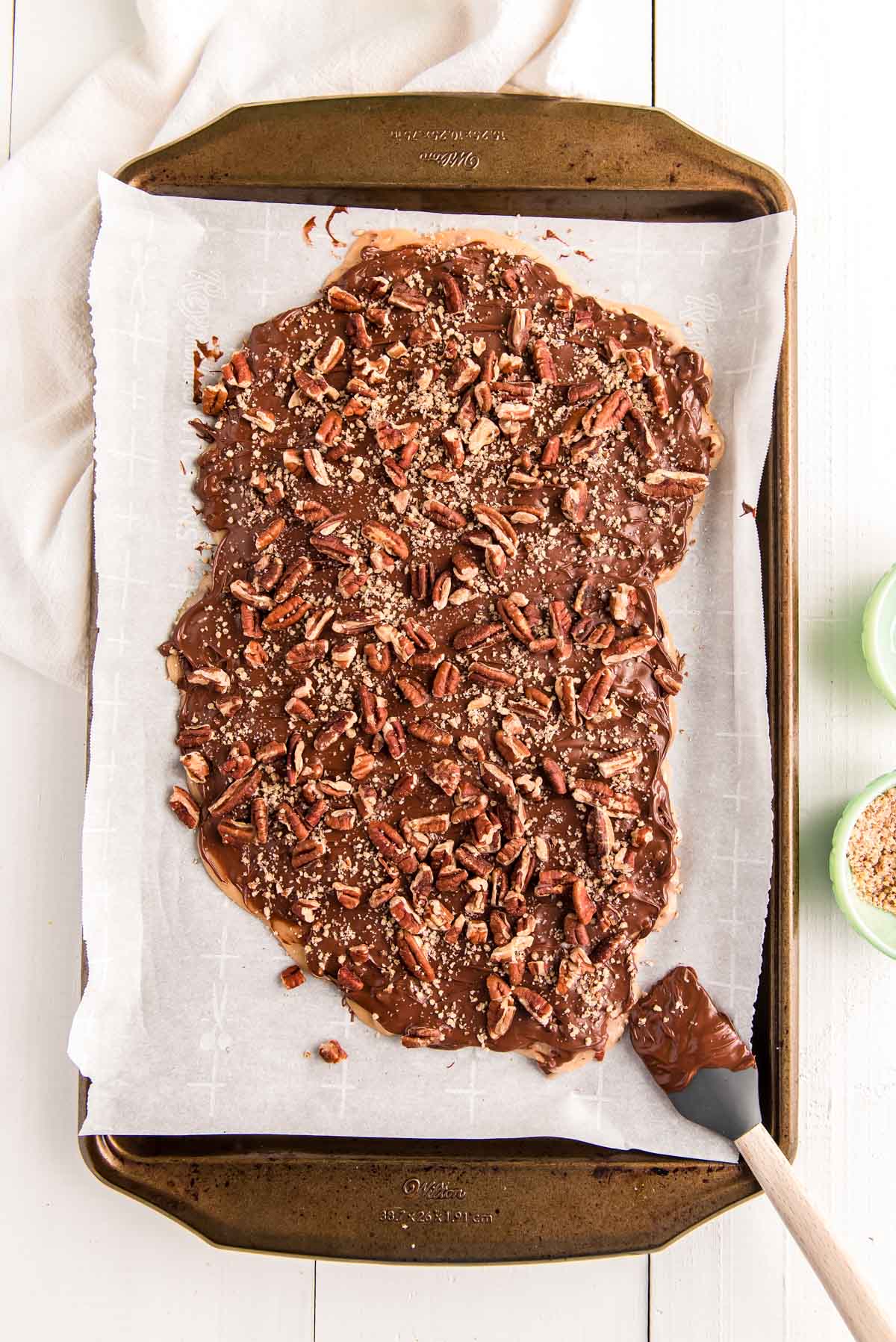 Overhead photo of toffee on a parchment-lined baking sheet.