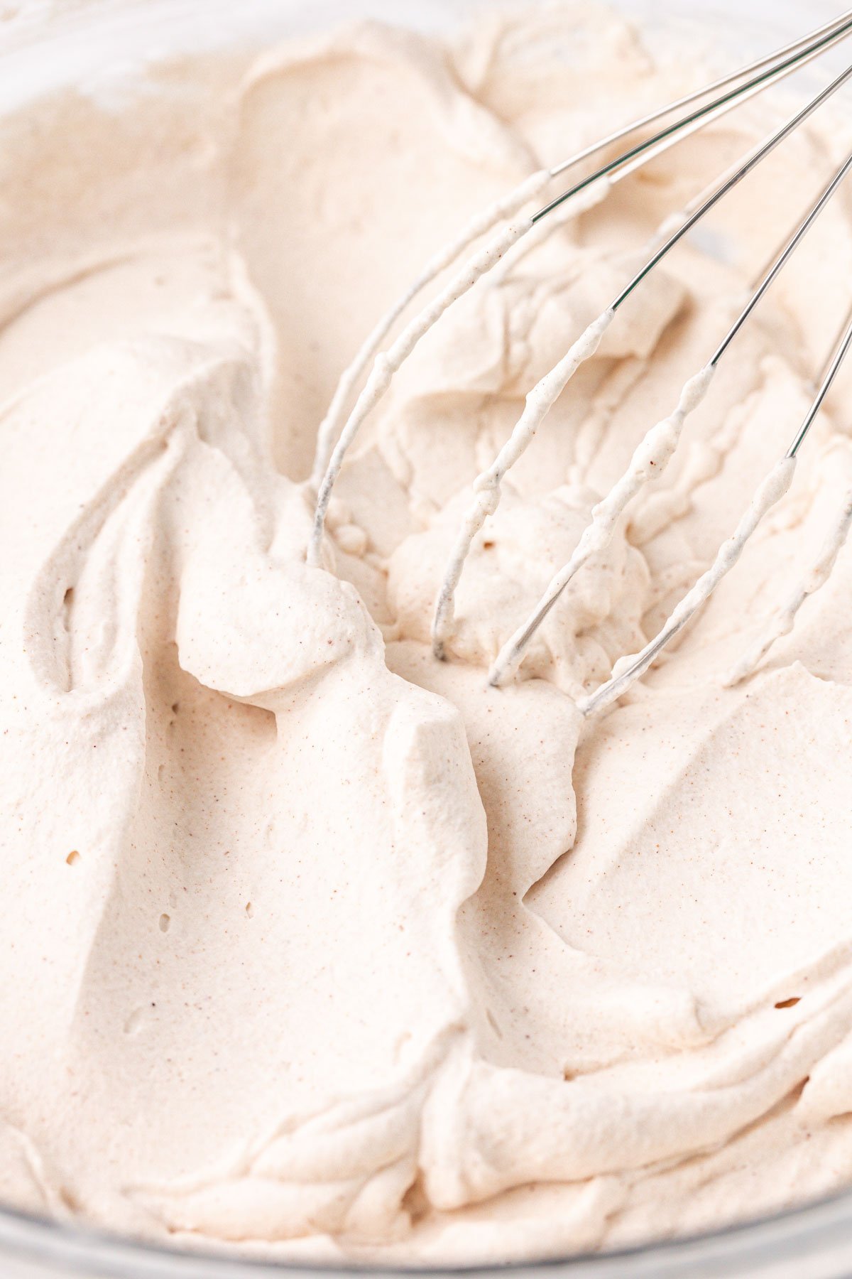 Whipped cream with cinnamon in a bowl.