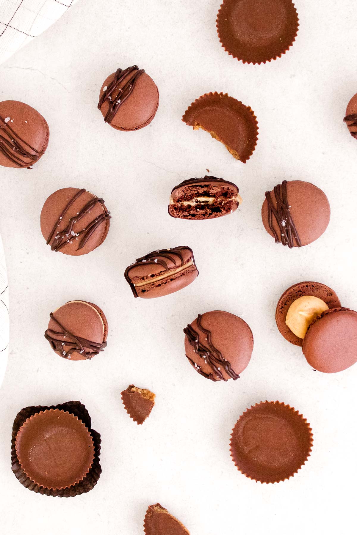 Overhead photo of peanut butter macarons on a white counter.