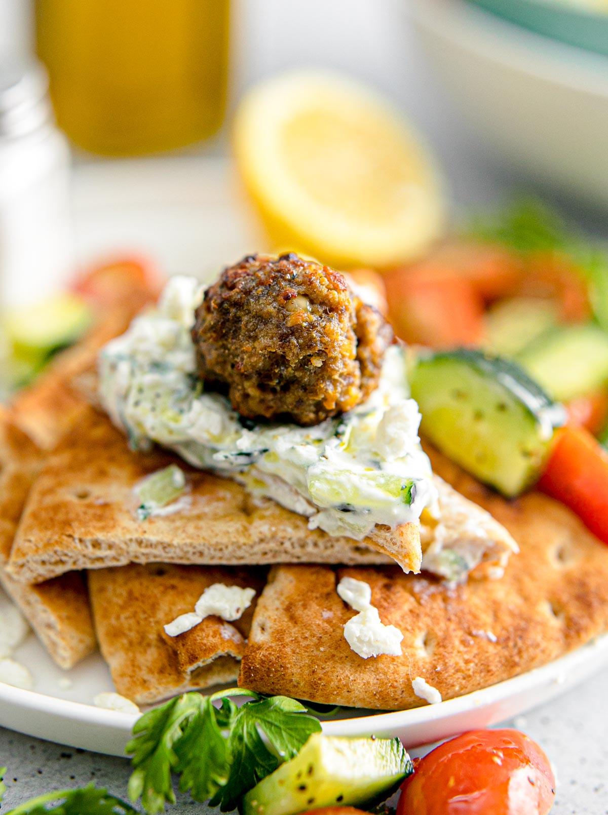 Greek meatballs with tzatziki sauce on pita bread.