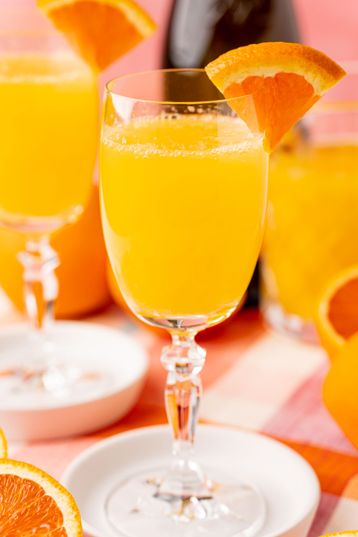 Close up of a mimosa garnished with orange.