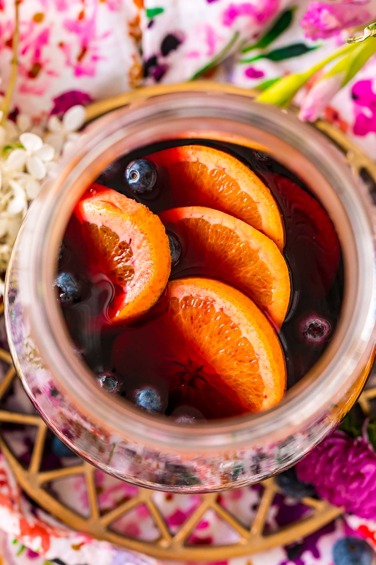 Overhead photo of a pitcher filled with blueberry sangria with orange slices and blueberries.