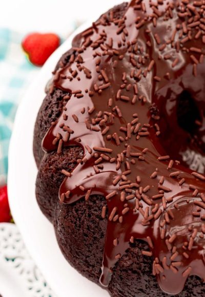 Angled photo of Devil's food cake bundt cake on a white cake stand.