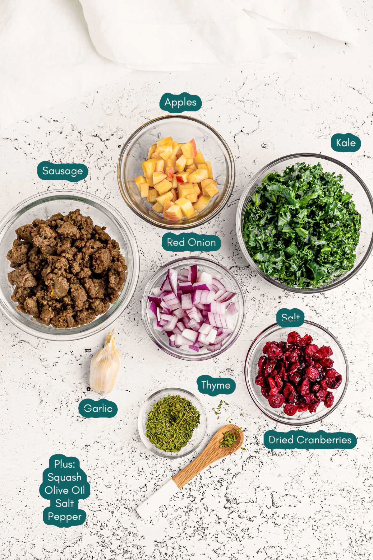 Ingredients to make stuffed acorn squash prepared on a marble surface.