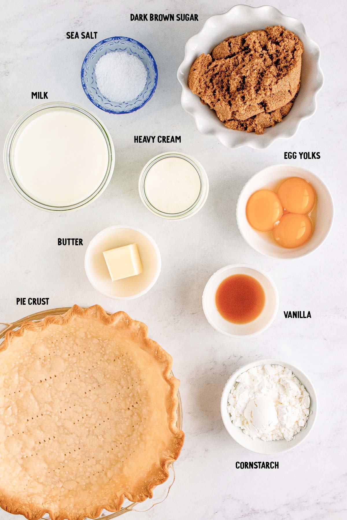 Overhead photo of ingredients to make butterscotch pie prepped on a marble counter.