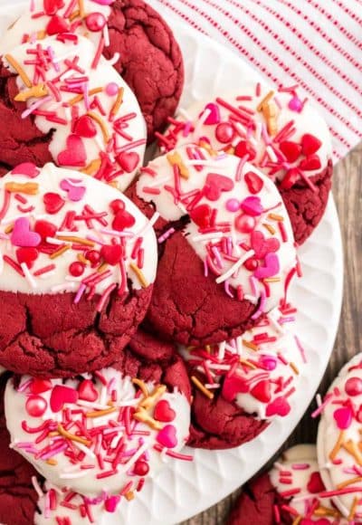 Close up photo of red velvet cookies decorated for Valentine's Day on a white plate.