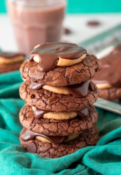 A stack of four buckeye cookies on a green napkin.