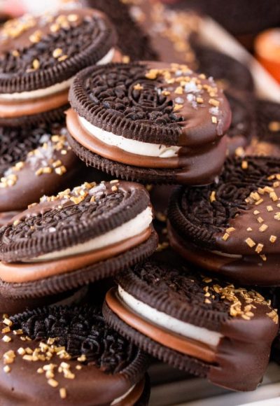 Close up of chocolate dipped oreos on a plate.