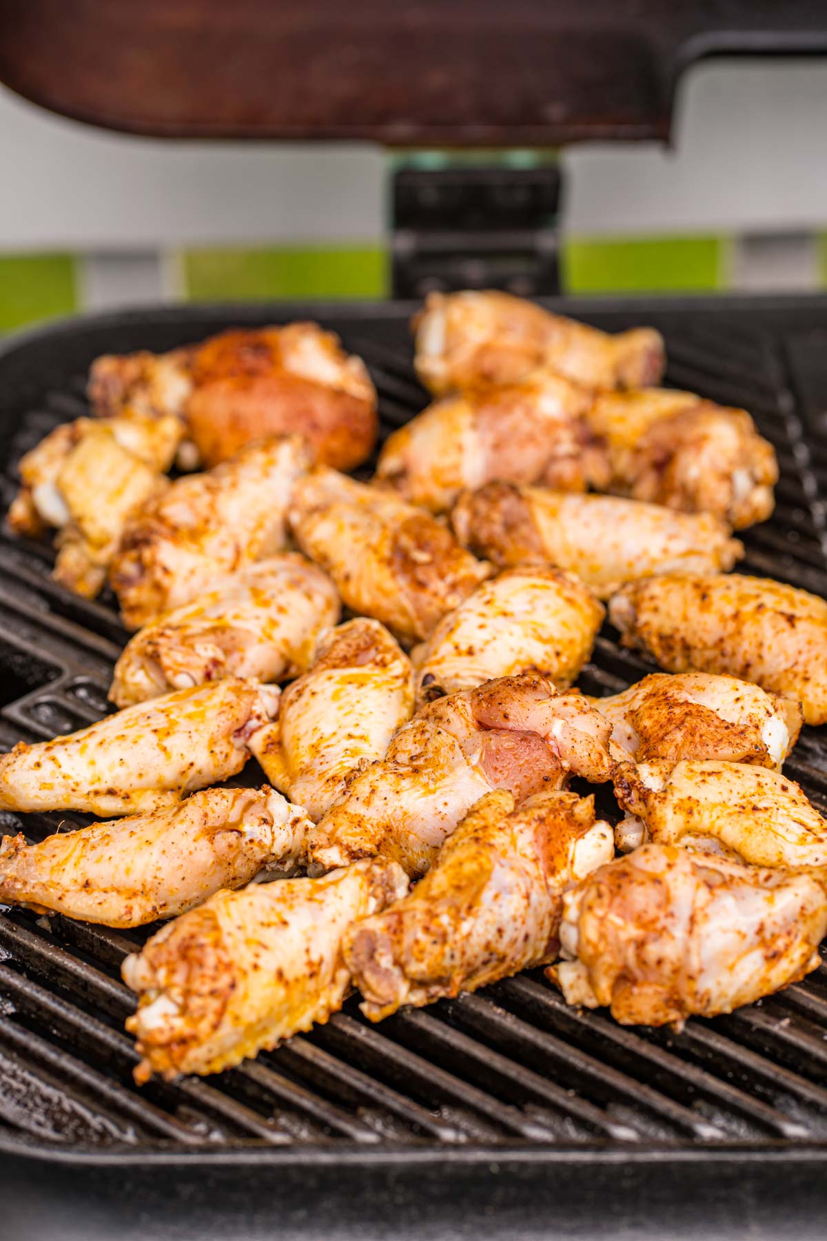 Chicken wings being grilled on a grill.