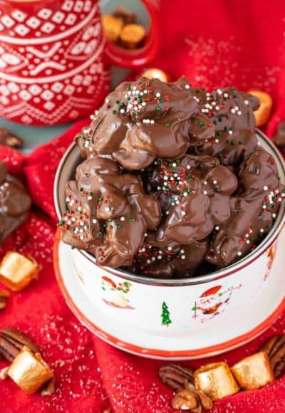 Crockpot turtle candy in a holiday bowl on a red napkin.