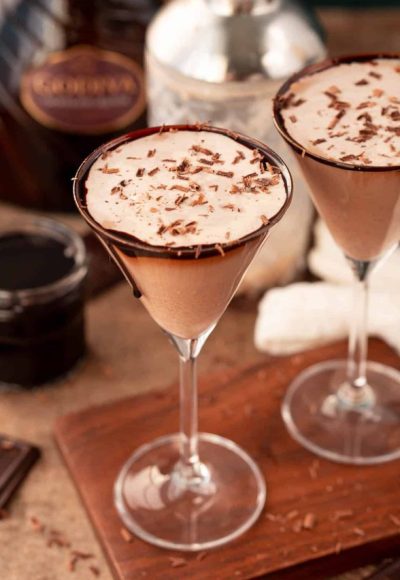 Close up photo of a chocolate martini on a wooden serving board.