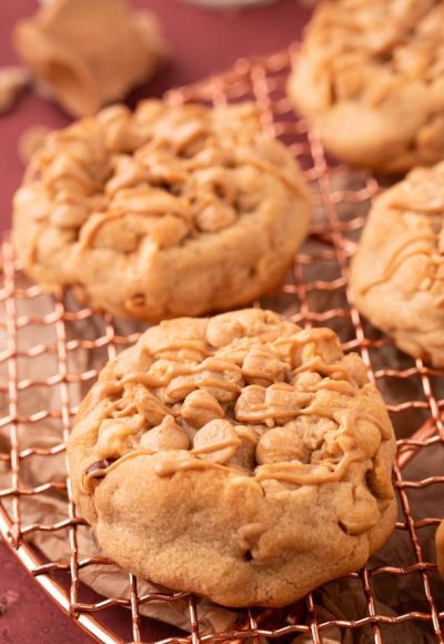 Thick Triple Peanut Butter Cookies on a copper wire rack.