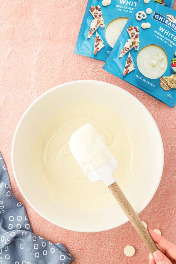 Melted white chocolate in a white bowl.