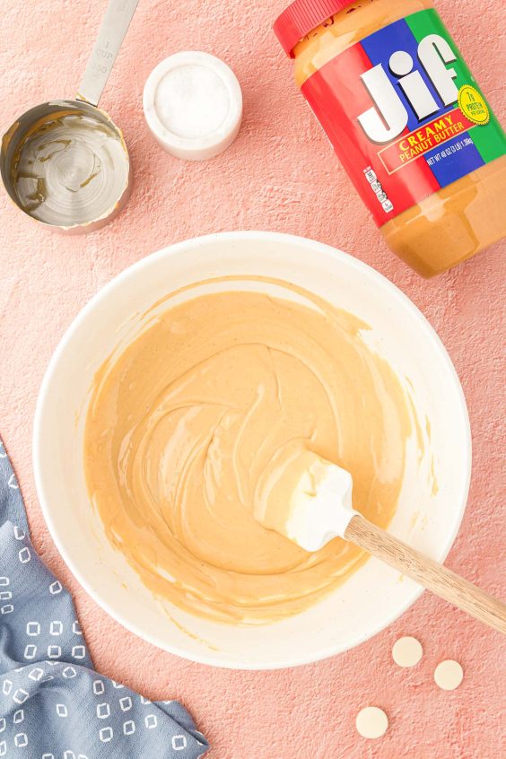 Peanut butter and white chocolate melted together in a white bowl.