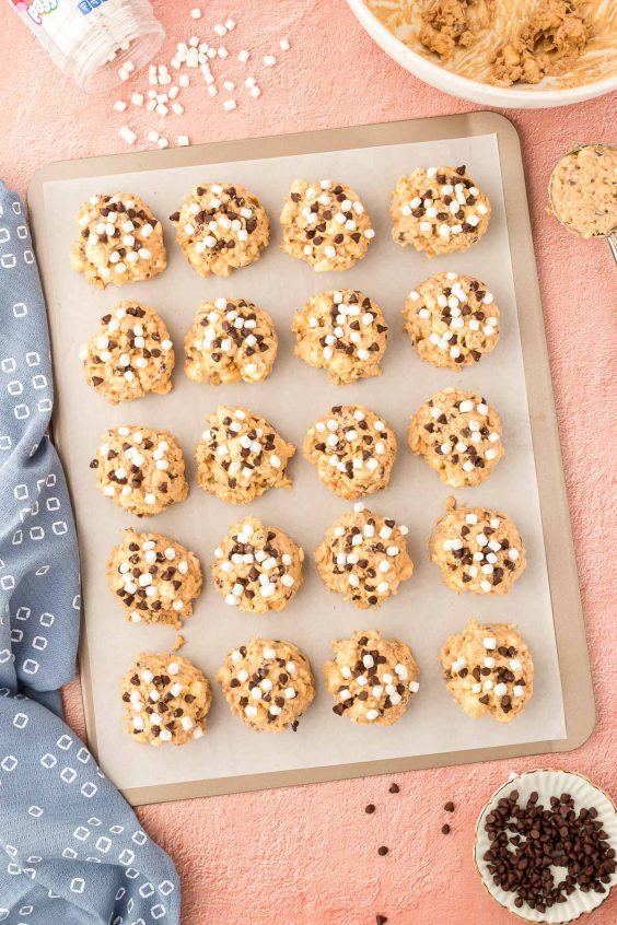 Avalanche cookies on a parchment paper lined baking sheet to set.