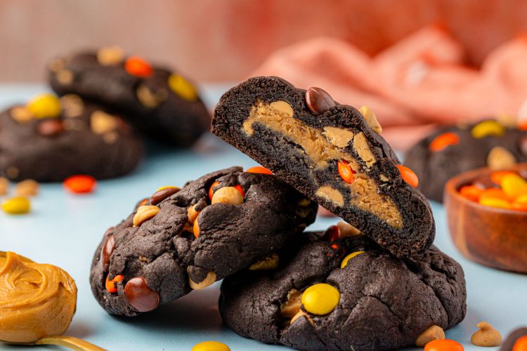 Chocolate peanut butter cookies on a blue table.