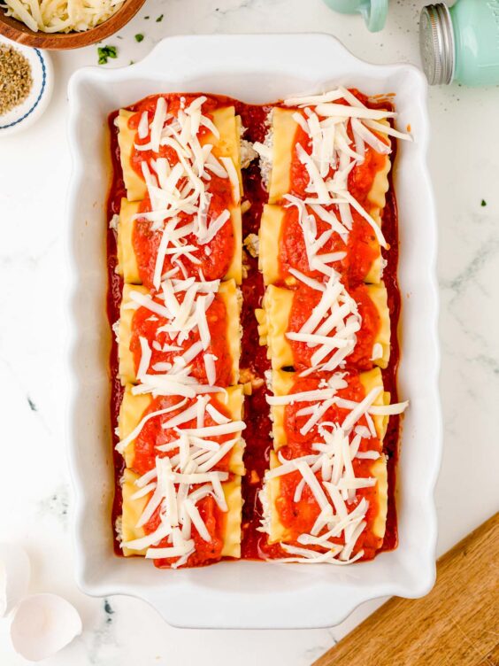 Lasagna roll ups in a baking dish ready to bake.