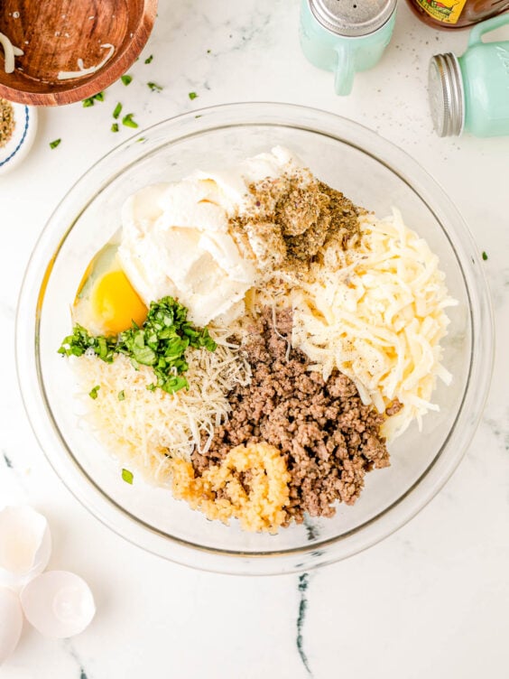 Ingredients to make ricotta filling for pasta in a bowl.