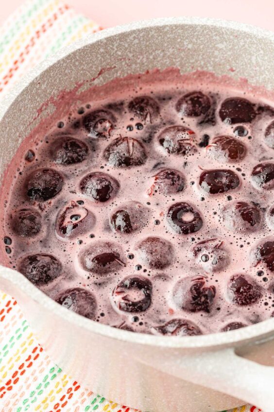 Cherries being simmered in a pot.