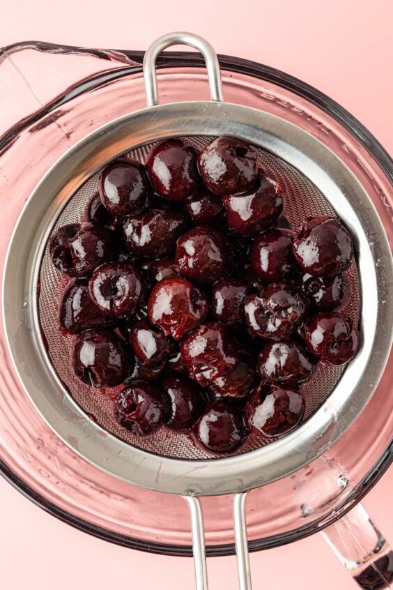 Cherry simple syrup being strained.