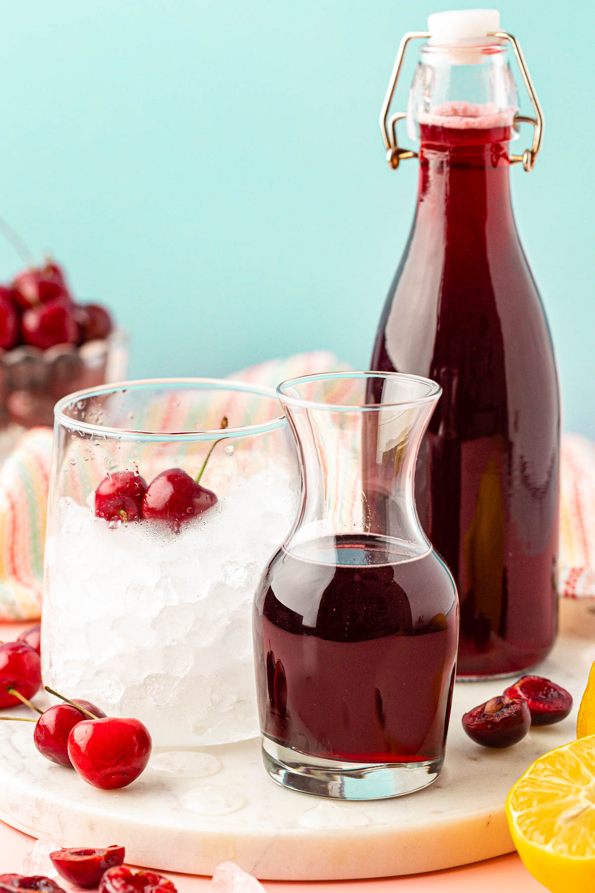 Cherry Simple Syrup next to a glass.